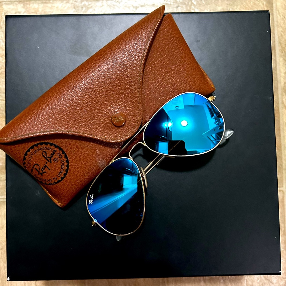 Ray Ban aviator’s sun glasses, blue Crome lens, gold frame w/brown case.
